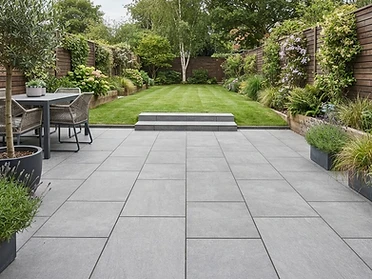 Grey porcelain slab patio with steps to the lawn