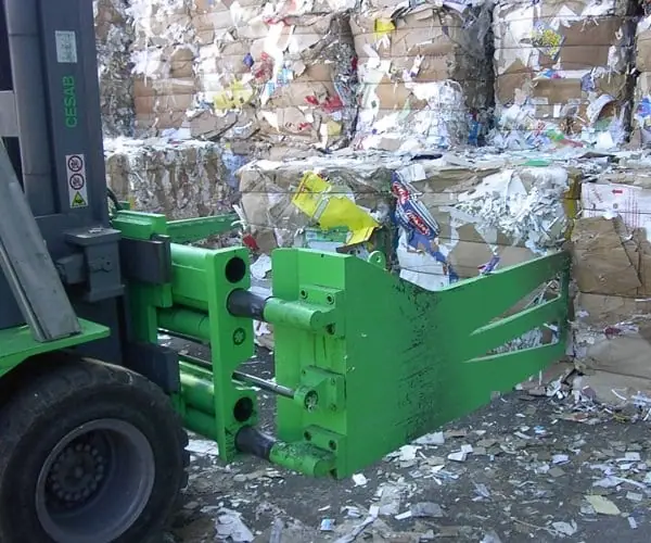 Forklift attachment on a tractor for recycling bales