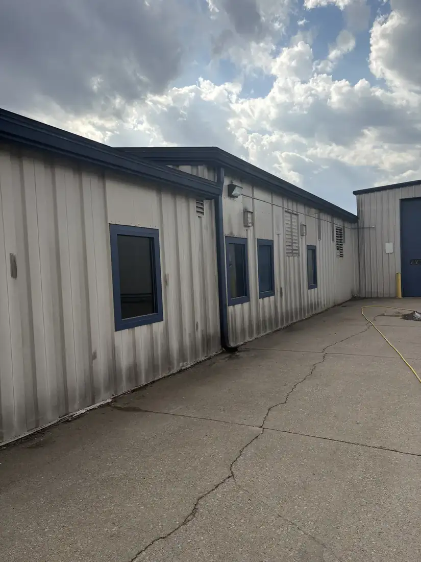 Commercial metal building exterior before washing, streaked and dirty