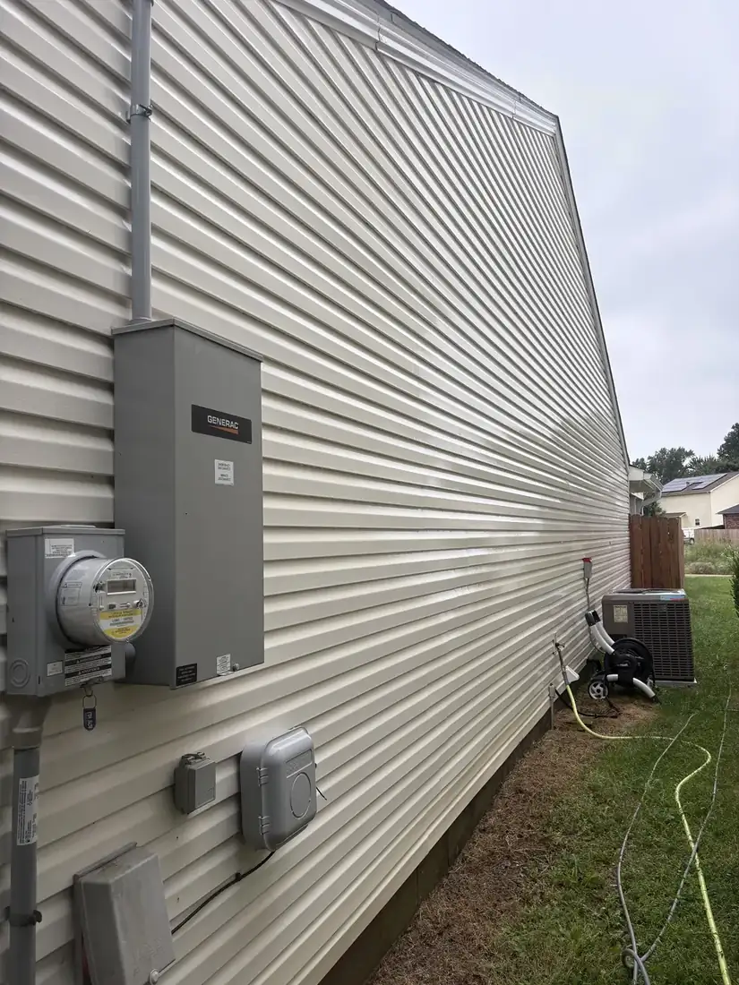 Vinyl siding before washing, streaked with dirt and mildew
