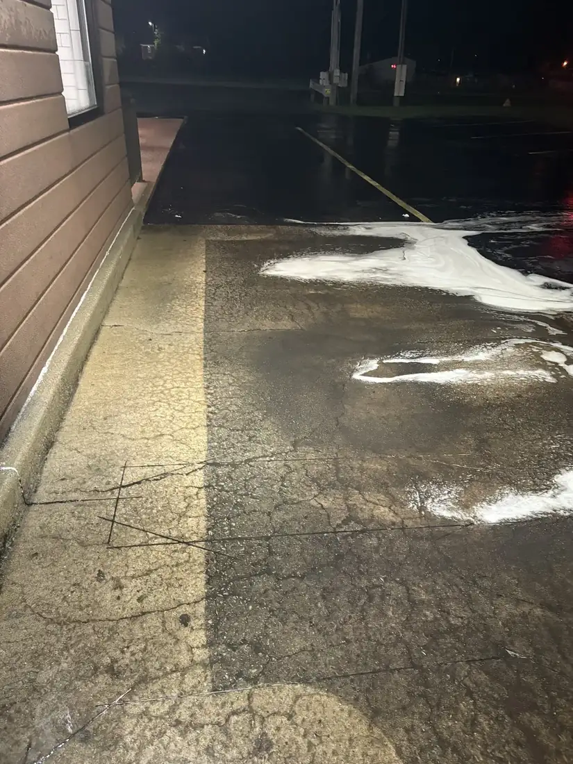 Commercial parking lot before and after night pressure washing