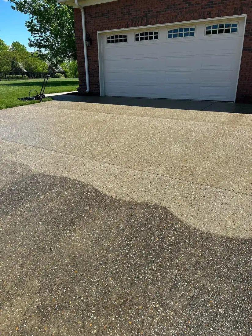 Driveway and garage apron before and after cleaning, half dark and half light