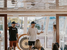 Jordan Dunin leading a workshop, gesturing as he speaks to a seated group