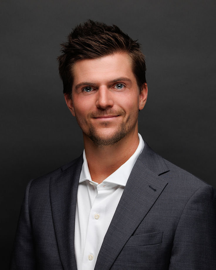 Jordan Dunin, keynote speaker, in a charcoal studio portrait