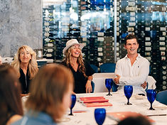 Jordan Dunin at a leadership dinner, seated around a table with guests
