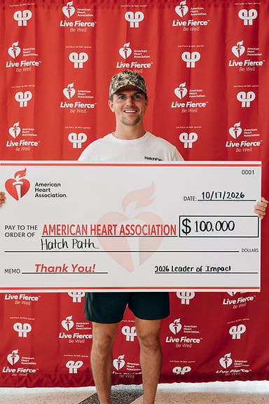 Jordan Dunin presenting a $100,000 ceremonial check to the American Heart Association as Leader of Impact