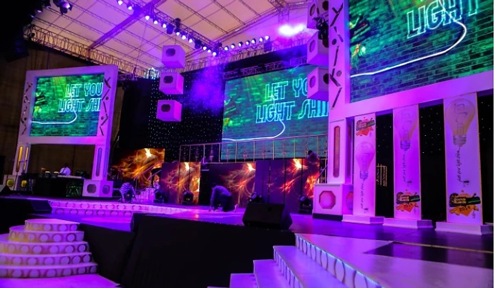 A THINK & XCITE MARKETING production stage with LED screens and purple stage lighting