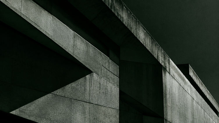 Brutalist concrete facade in deep shadow
