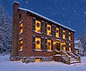 Snow-covered historic inn in Gettysburg at dusk