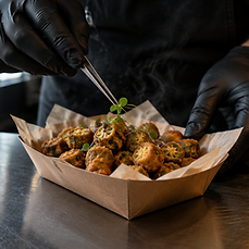 Plating the okra. Tweezers on a truck.