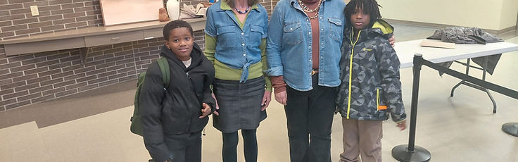 Two JACEF tutors standing with two students at an after-school tutoring session