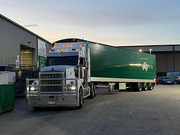 White Kenworth truck with a green Wheelie Waste trailer at the Material Recovery Facility