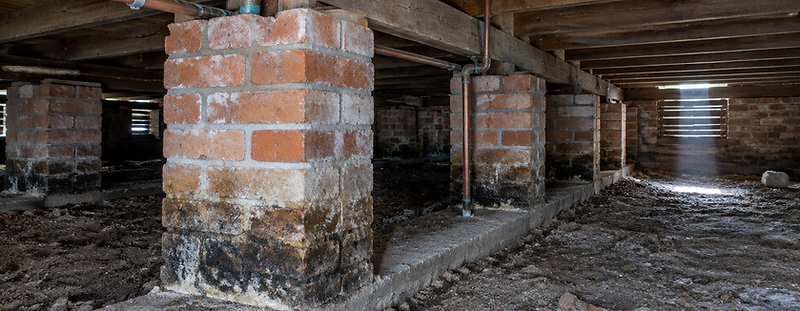 Brick piers and timber bearers inside the subfloor of an older Australian house