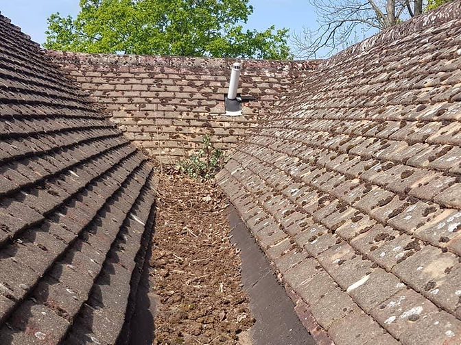 Before: Roof valley cleared and re-sealed