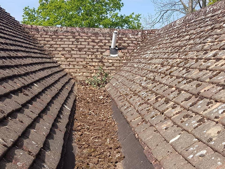 Before: Roof valley cleared and re-sealed