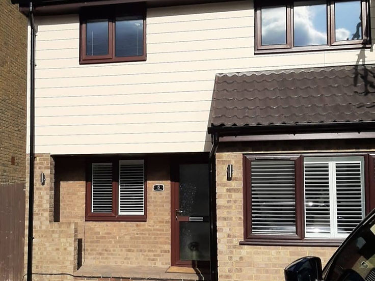 After: Upper storey re-clad in cream shiplap