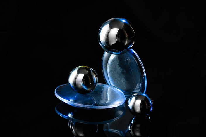 Balanced silver spheres and glass plates
