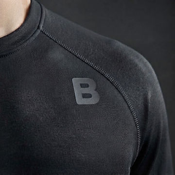 Close-up of charcoal technical jersey with a small tonal geometric B printed on the chest