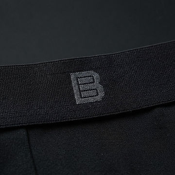 Close-up of a black boxer brief waistband with the geometric B woven into the centre