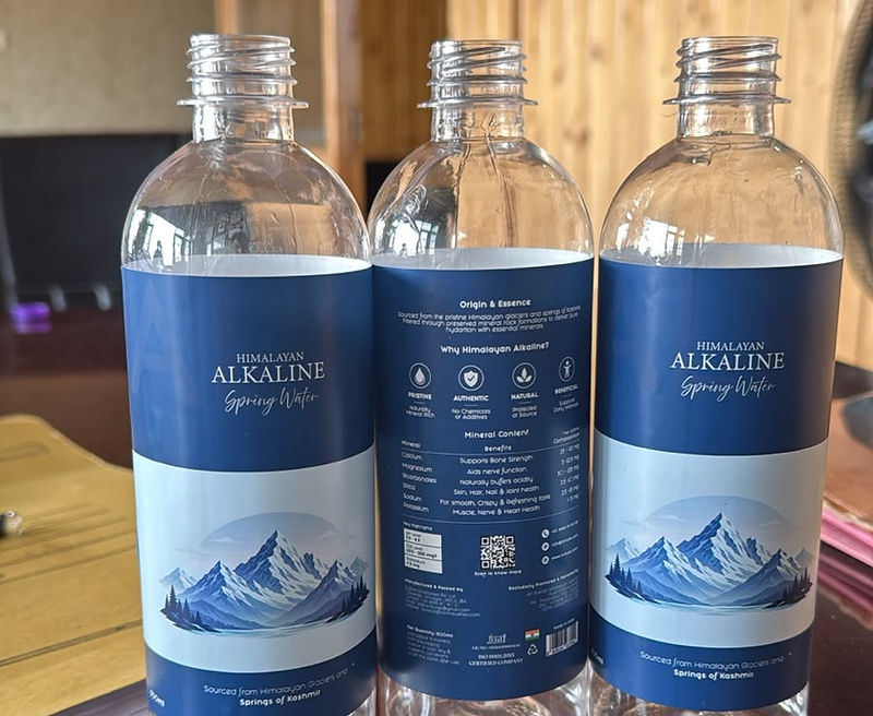 Three bottles of Himalayan Alkaline Spring Water with the Kashmir mountain label