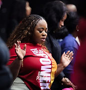A woman worshipping with her hands raised