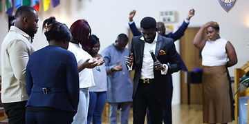 Dr Evans Oppong ministering with a microphone
