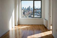 An empty apartment unit with sunlight across the floor