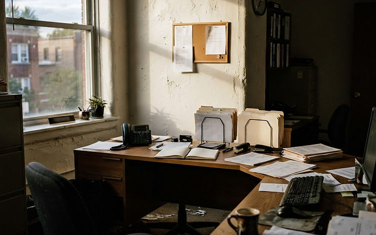 An empty leasing office desk in late afternoon light