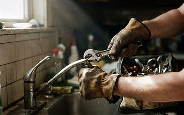 A maintenance technician repairing a kitchen faucet
