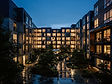 A modern apartment community courtyard at dusk