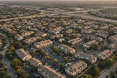 Aerial view of a suburban apartment submarket at golden hour