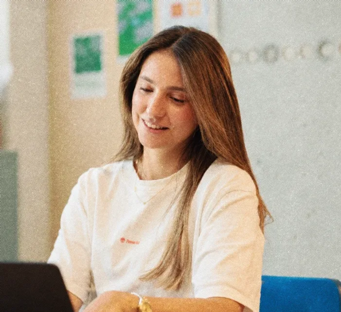 A colleague smiling at her laptop