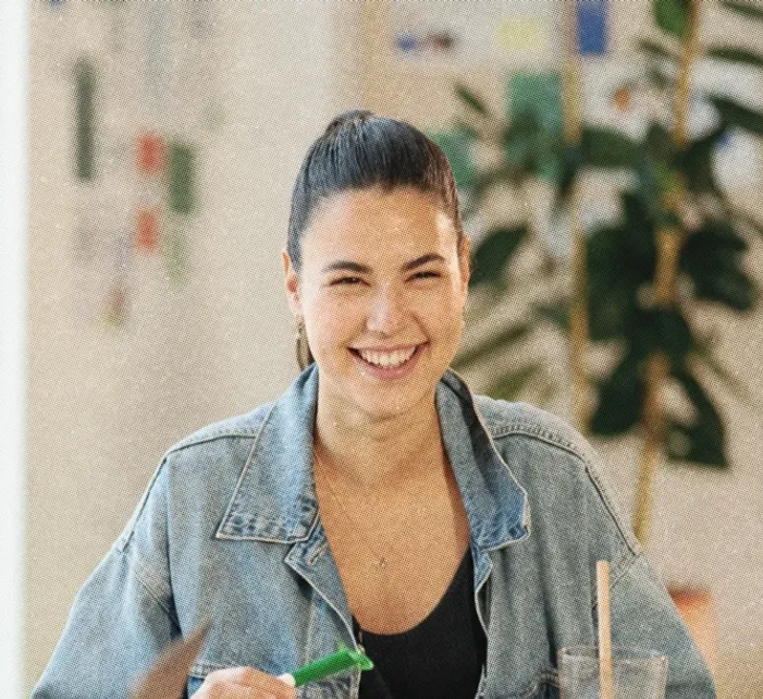 A colleague laughing, a pen in her hand
