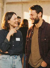 People laughing together at an event