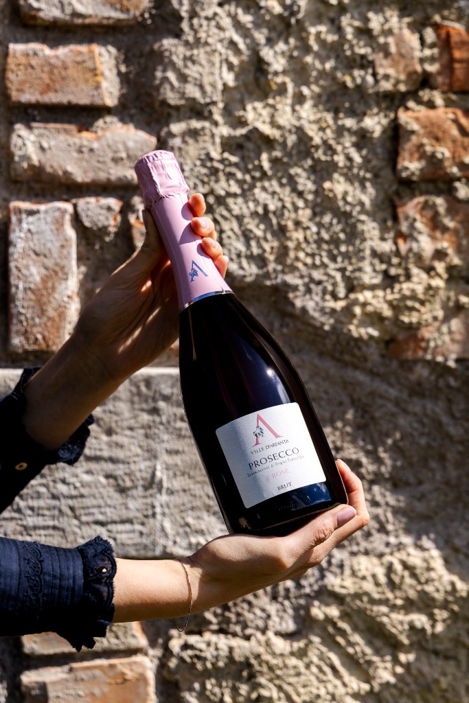 Ville D'Arfanta Prosecco bottles against stone wall — wholesale wine available in Malta