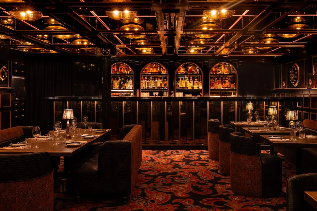 The Indian Club House Oslo lounge — velvet seating and warm copper light