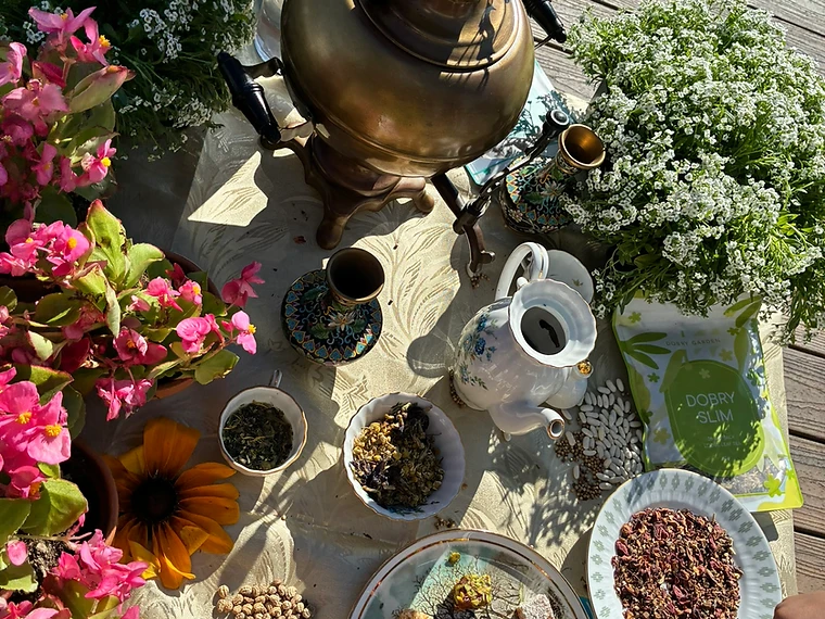 The painted porcelain teapot and brass samovar on the garden table