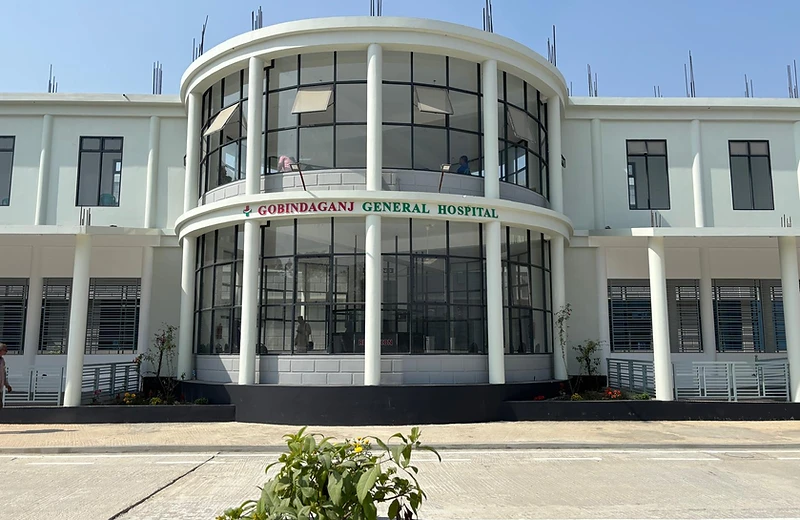 Gobindaganj General Hospital front façade with curved glass entrance