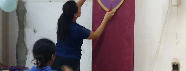 Team members preparing decorations for a vacation Bible school at the church