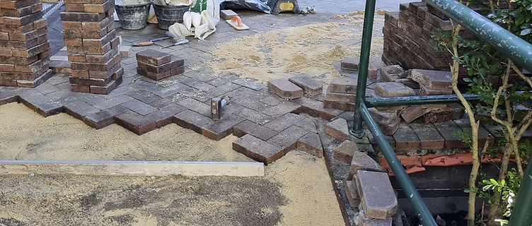 Active residential paving repair with pavers re-laid