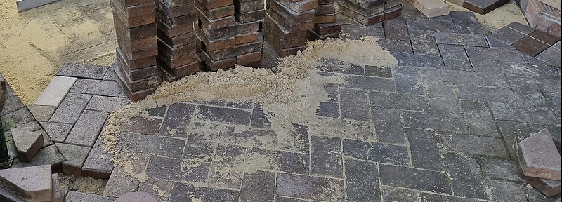 Residential paving being re-levelled