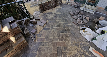Loose pavers being re-bedded