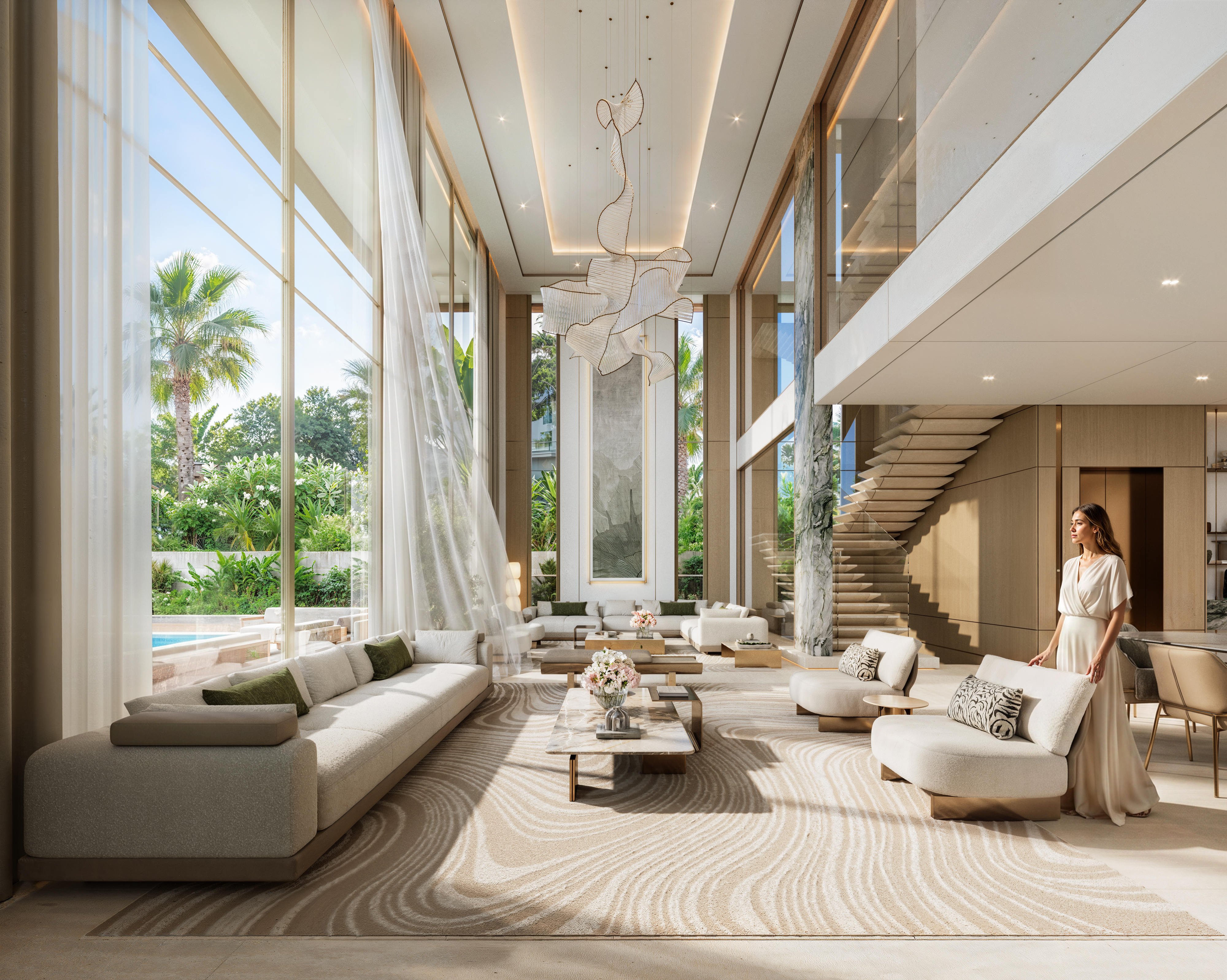 Double-height living room of a Tilal Islands Mansion with sculptural chandelier and marble pillar