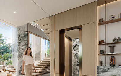 Foyer with bronze-framed lift and marble column