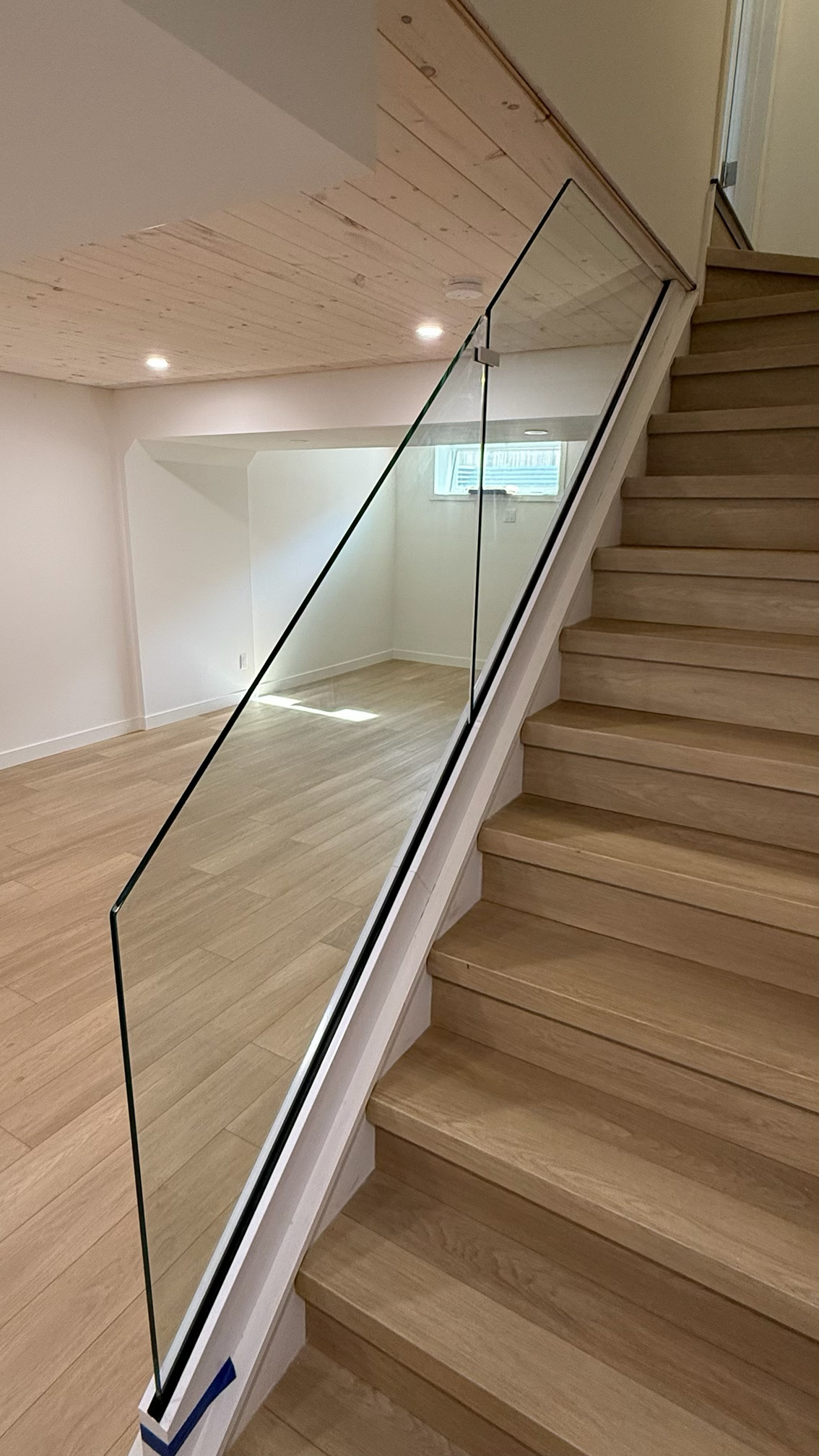 Modern glass stair railing in a Winnipeg home with open sightlines
