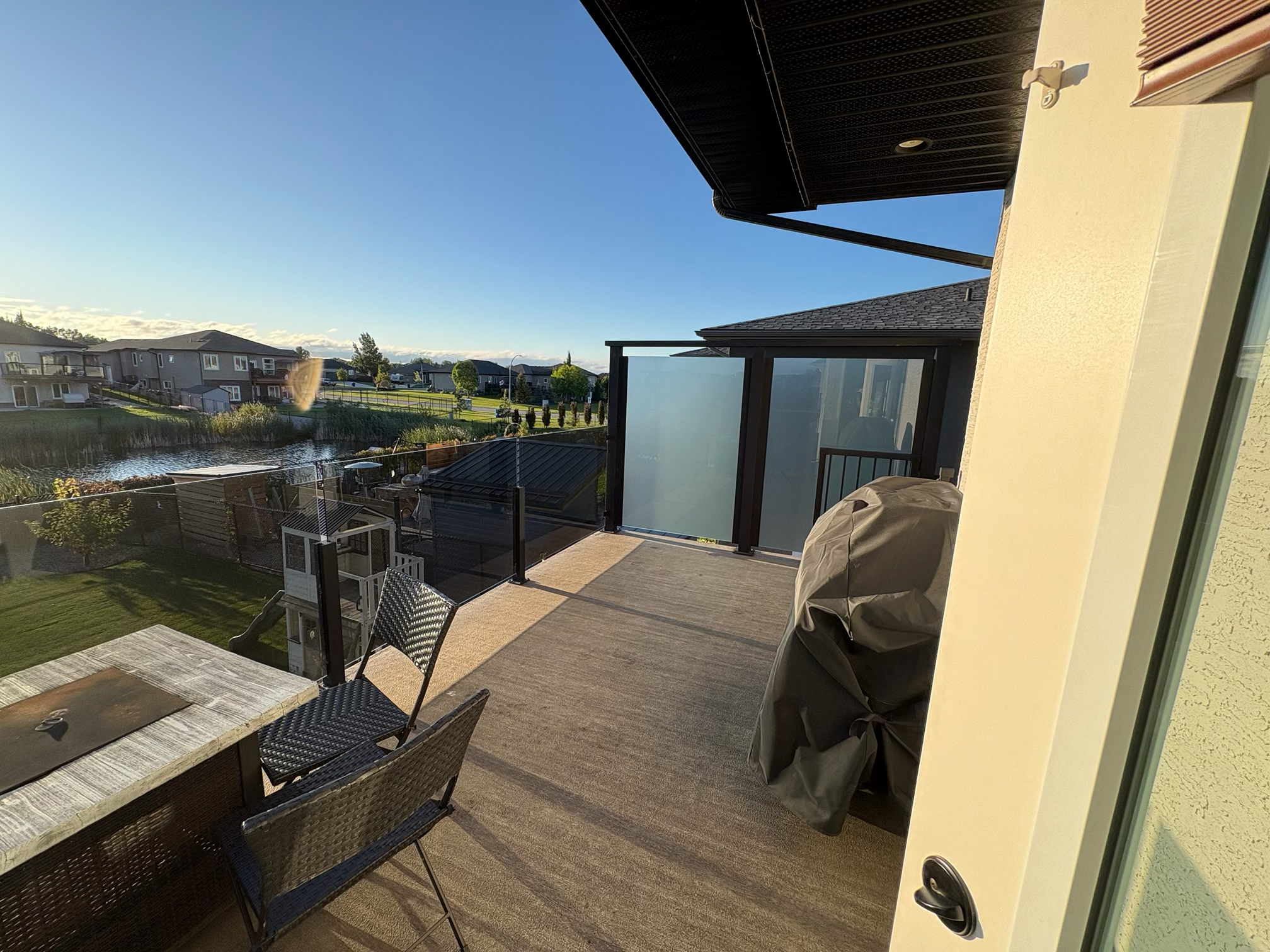 Exterior glass deck railing and privacy screen installation in Manitoba