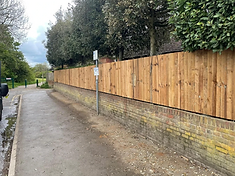 Closeboard wooden fence installed along a road in Surrey