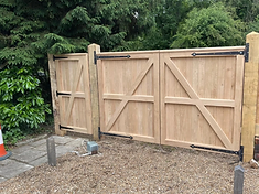 Bespoke wooden entrance gate installed in Farnham