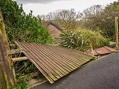 Wooden fence blown down by strong winds