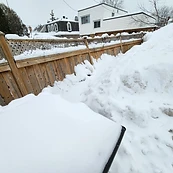 Storm-damaged fence blown down